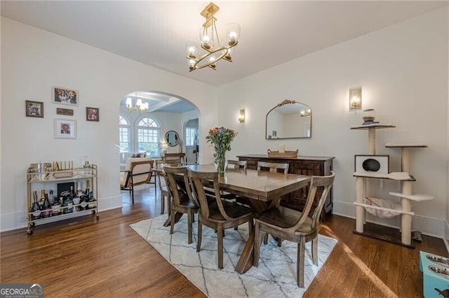 dining area with hardwood / wood-style flooring and a chandelier