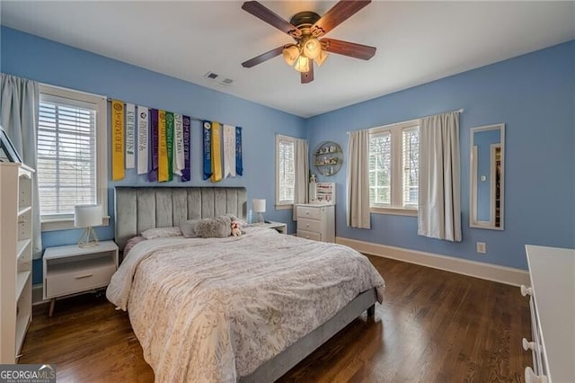 bedroom with ceiling fan and dark hardwood / wood-style floors