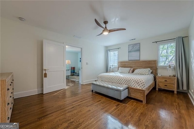 bedroom with multiple windows, dark wood-type flooring, and ceiling fan