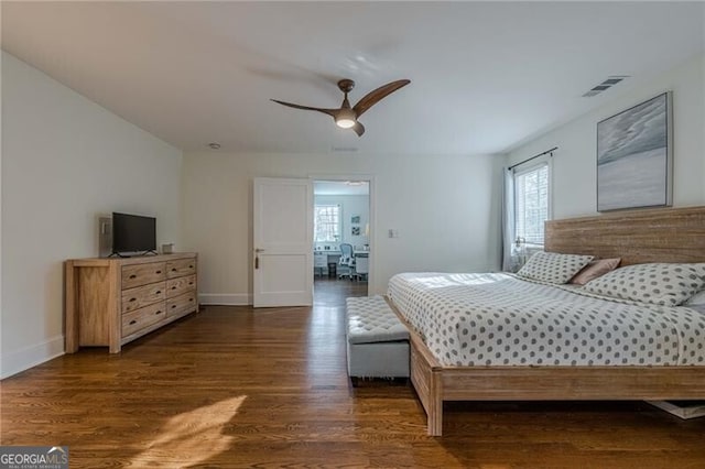 bedroom with dark hardwood / wood-style floors and ceiling fan