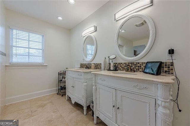 bathroom featuring vanity and backsplash