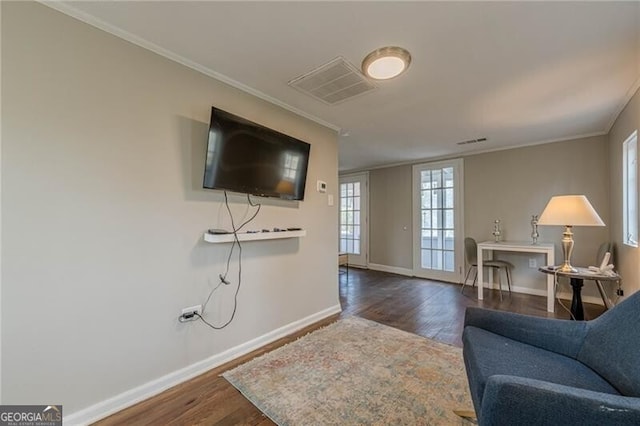 living room featuring ornamental molding and dark wood-type flooring