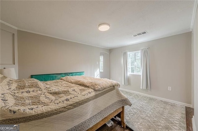 bedroom featuring crown molding and carpet