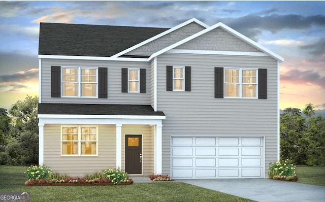 view of front of home featuring a yard and a garage