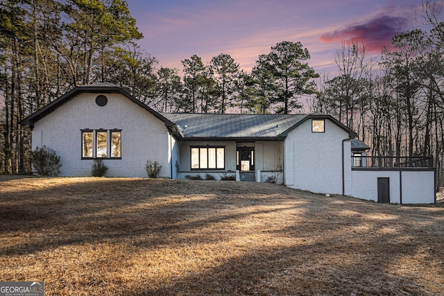 ranch-style house with a lawn