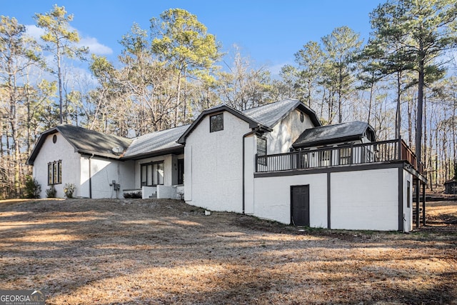 view of side of property featuring a wooden deck