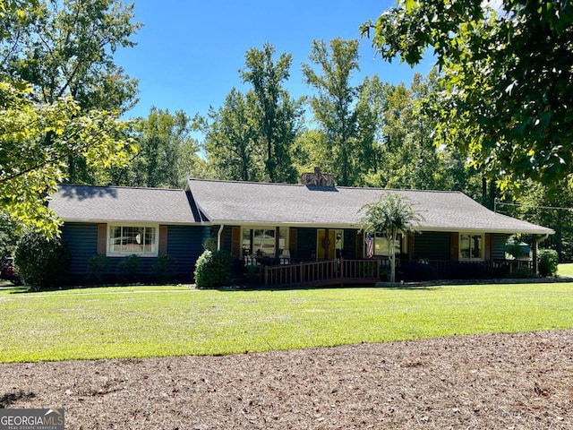 ranch-style home with covered porch and a front lawn