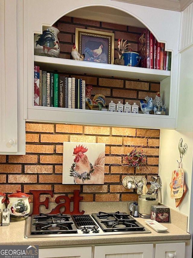 details with white cabinets and stainless steel gas stovetop