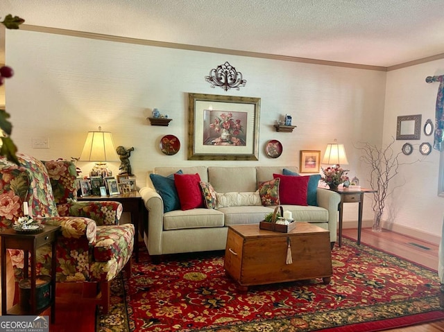 living room featuring crown molding, dark hardwood / wood-style flooring, and a textured ceiling