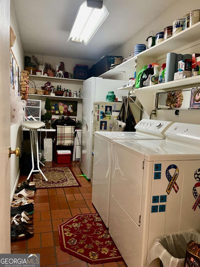 clothes washing area with washing machine and dryer