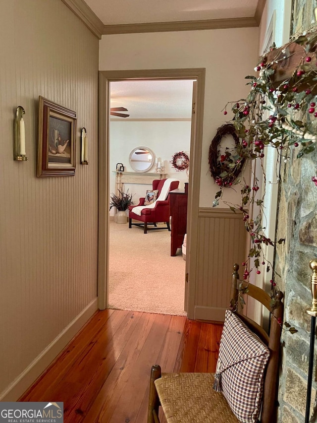 corridor featuring hardwood / wood-style flooring and ornamental molding