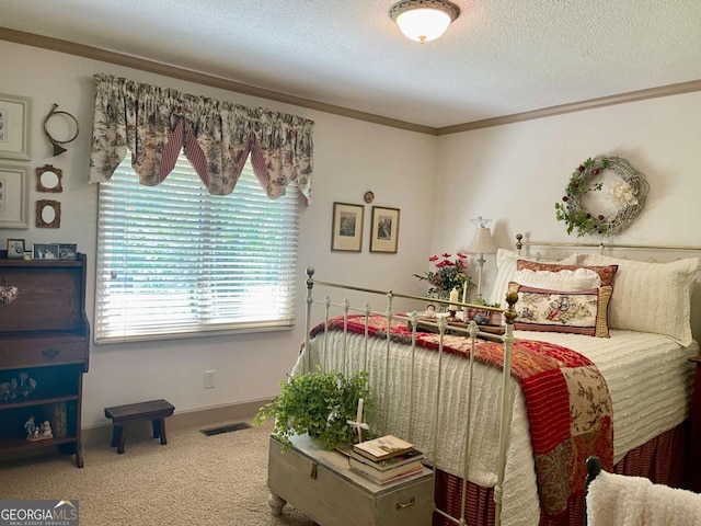 bedroom with crown molding, carpet flooring, and a textured ceiling