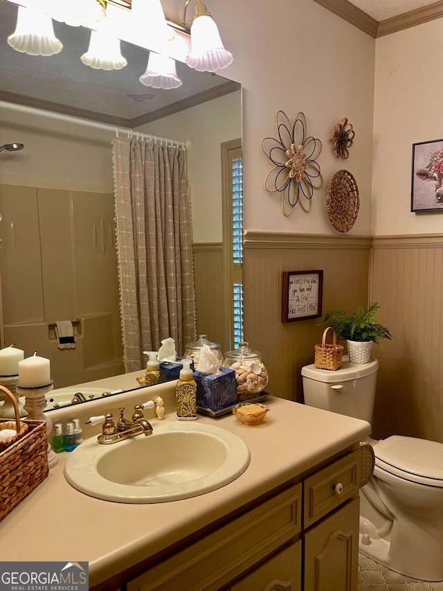 full bathroom with vanity, crown molding, shower / bath combination with curtain, and toilet