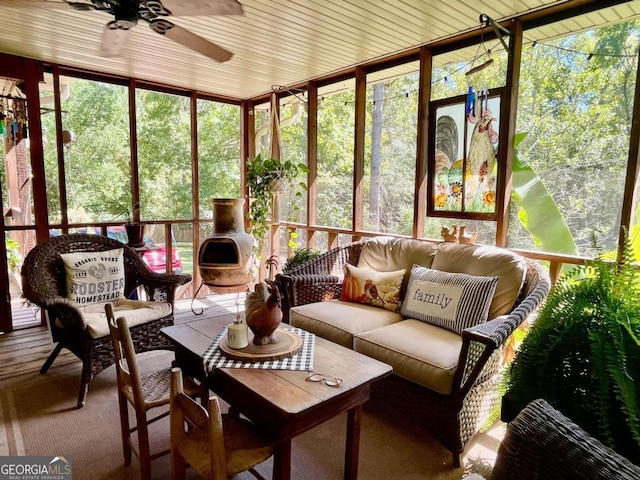 sunroom / solarium featuring ceiling fan