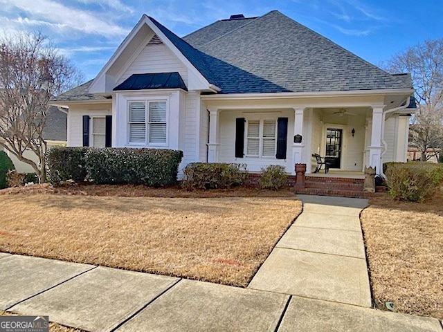 view of front of property with a porch and a front lawn