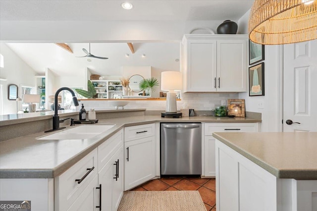 kitchen featuring dishwasher, light tile patterned floors, a sink, and white cabinets