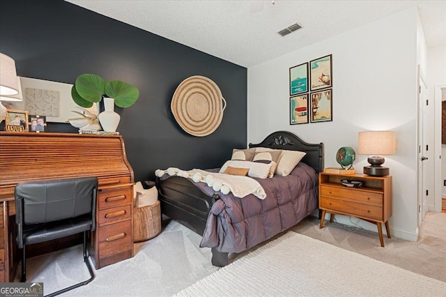 bedroom featuring baseboards, a textured ceiling, visible vents, and light colored carpet