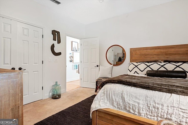 bedroom featuring baseboards and light colored carpet