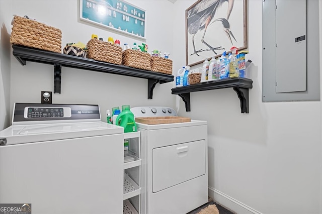 laundry area featuring laundry area, electric panel, baseboards, and separate washer and dryer