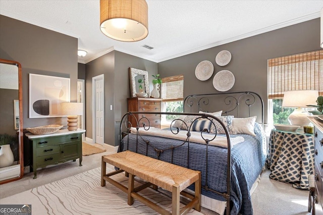 bedroom featuring light carpet, ornamental molding, a textured ceiling, and visible vents