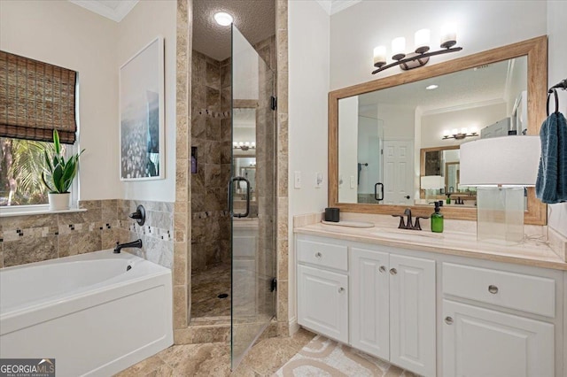 full bathroom featuring a stall shower, a garden tub, crown molding, and vanity