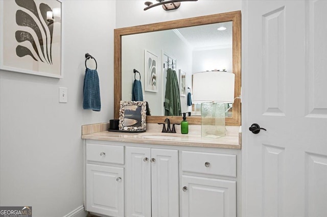 bathroom with vanity and crown molding