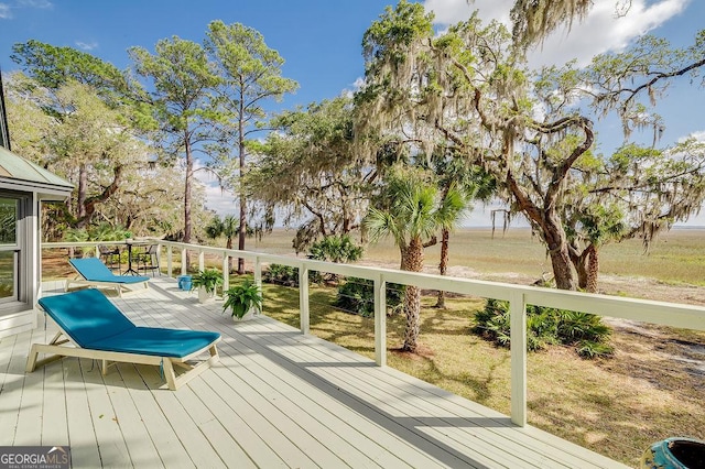 wooden terrace featuring a lawn