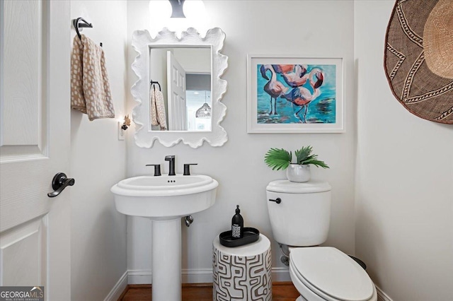 bathroom featuring toilet and baseboards