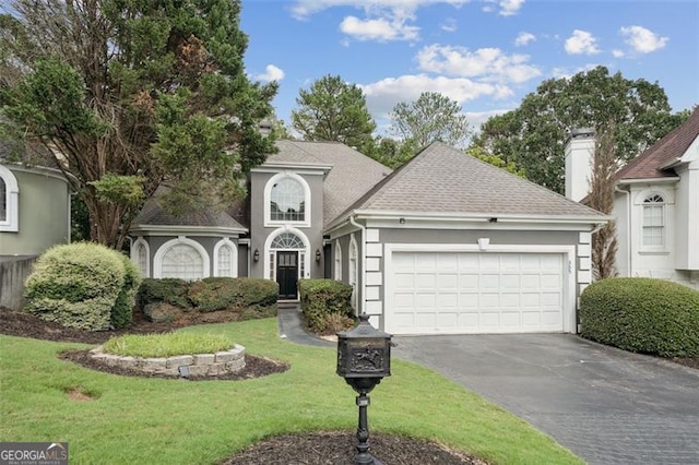 front of property with a front lawn and a garage