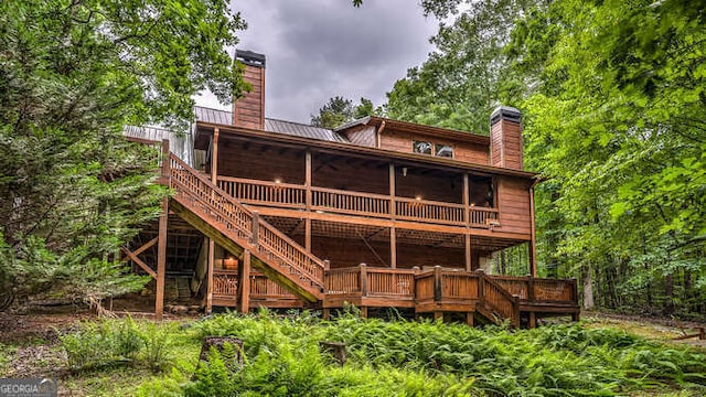 back of property featuring a wooden deck