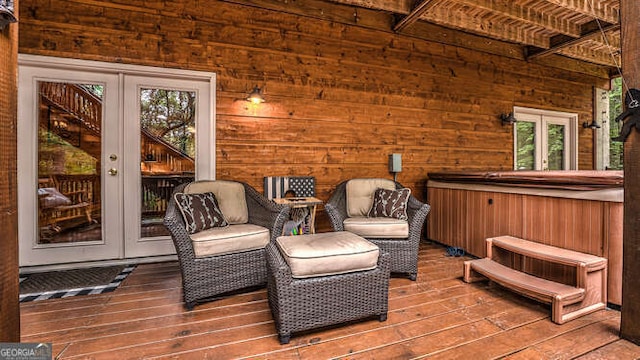 living area with wood-type flooring, wood walls, and french doors