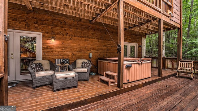 wooden deck featuring a hot tub