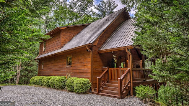 view of side of property with covered porch