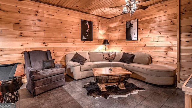 living room with wooden walls, wooden ceiling, and ceiling fan