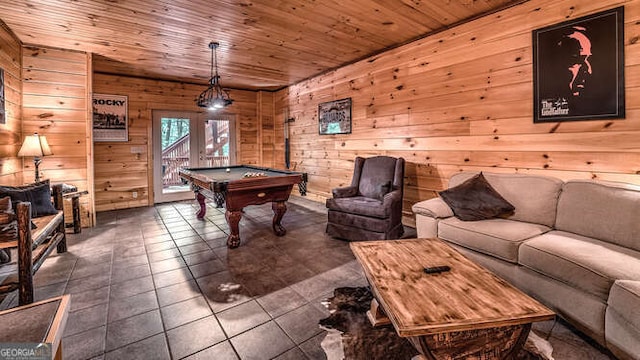 game room featuring wooden walls, pool table, dark tile patterned flooring, and wood ceiling