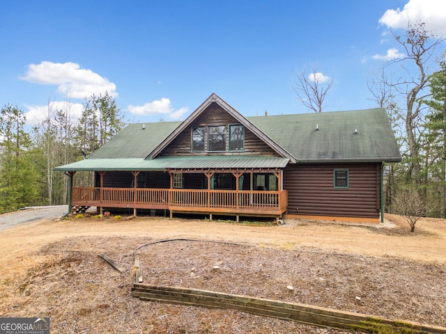 view of front facade with a porch and dirt driveway