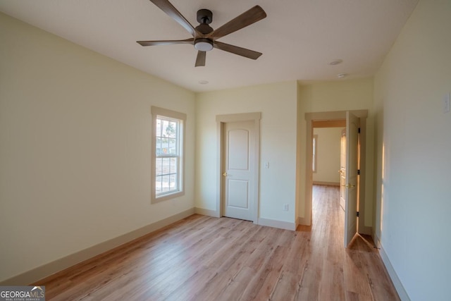 unfurnished bedroom with ceiling fan and light hardwood / wood-style floors