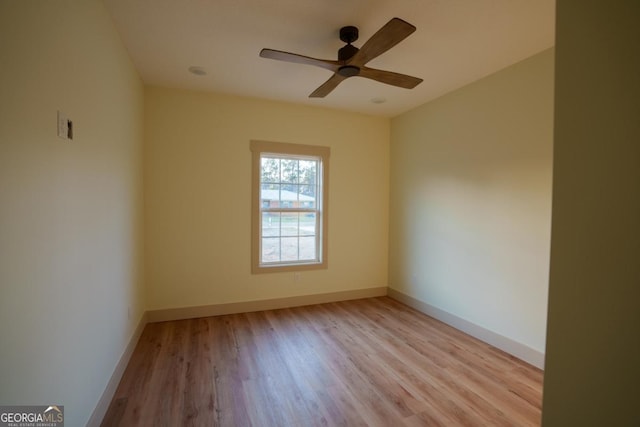 spare room with light hardwood / wood-style floors and ceiling fan