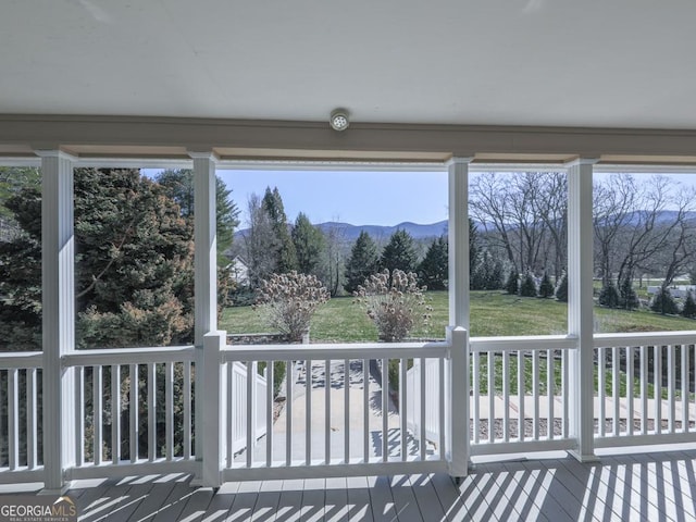 sunroom / solarium featuring a mountain view