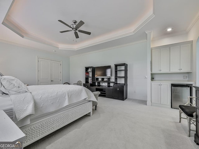 bedroom featuring ornamental molding, light carpet, stainless steel refrigerator, and a raised ceiling