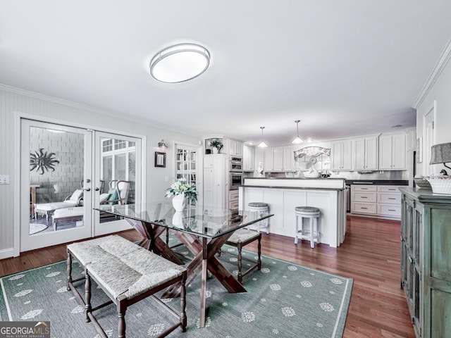 dining area featuring dark hardwood / wood-style floors, french doors, and ornamental molding