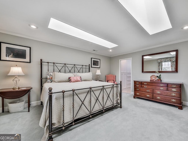 bedroom featuring crown molding, light carpet, and a skylight