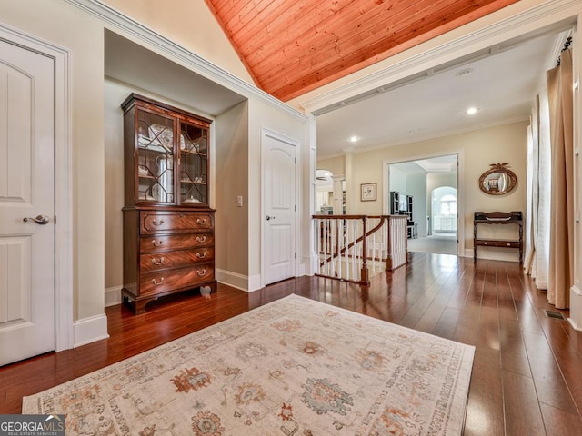 interior space with lofted ceiling, crown molding, wooden ceiling, and dark wood-type flooring