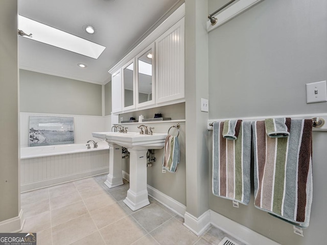 bathroom with a tub, tile patterned floors, and a skylight