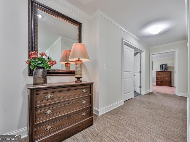 hallway featuring ornamental molding and light carpet