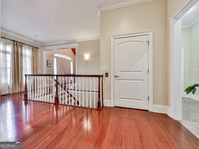 empty room with hardwood / wood-style flooring and ornamental molding