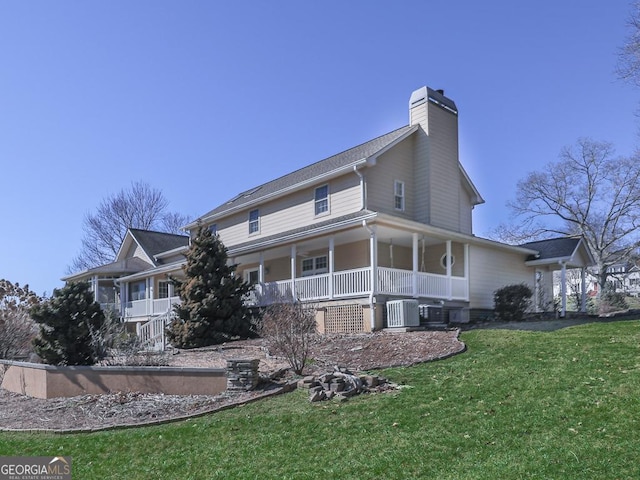 view of property exterior featuring a yard, central air condition unit, and a porch