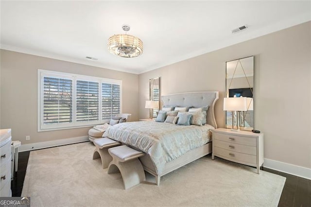 bedroom with ornamental molding and hardwood / wood-style flooring