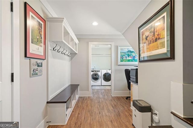 mudroom with light hardwood / wood-style flooring and separate washer and dryer