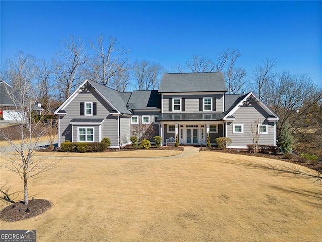 view of front facade featuring a front yard and french doors